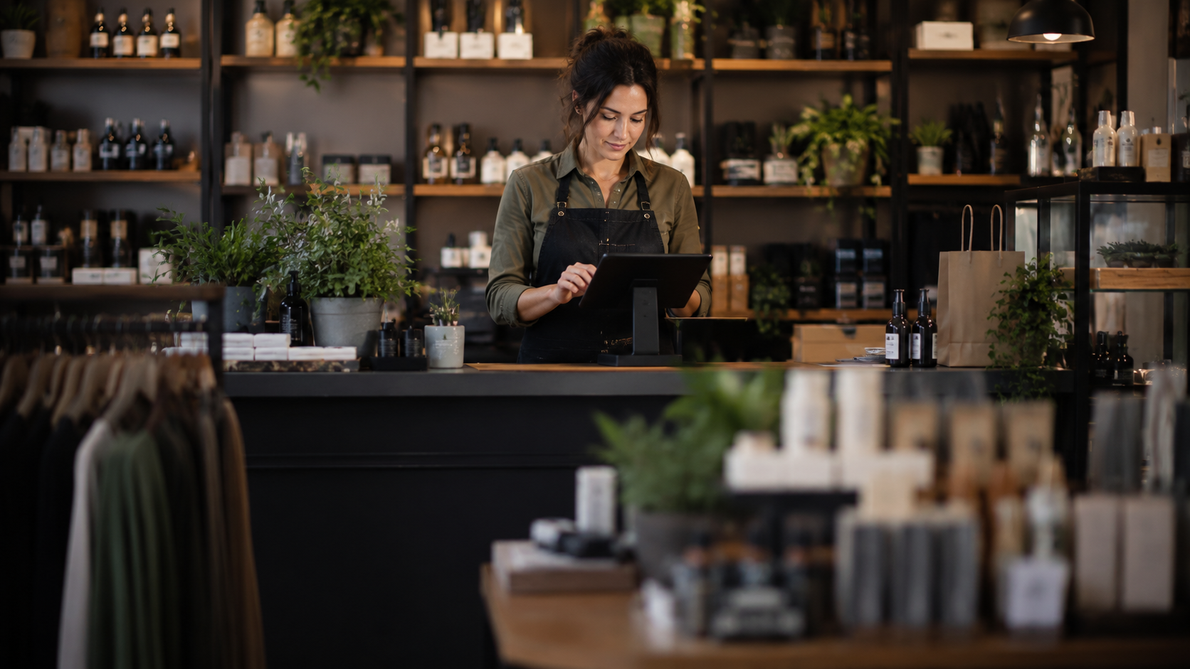 Small retail shop owner using a point-of-sale terminal